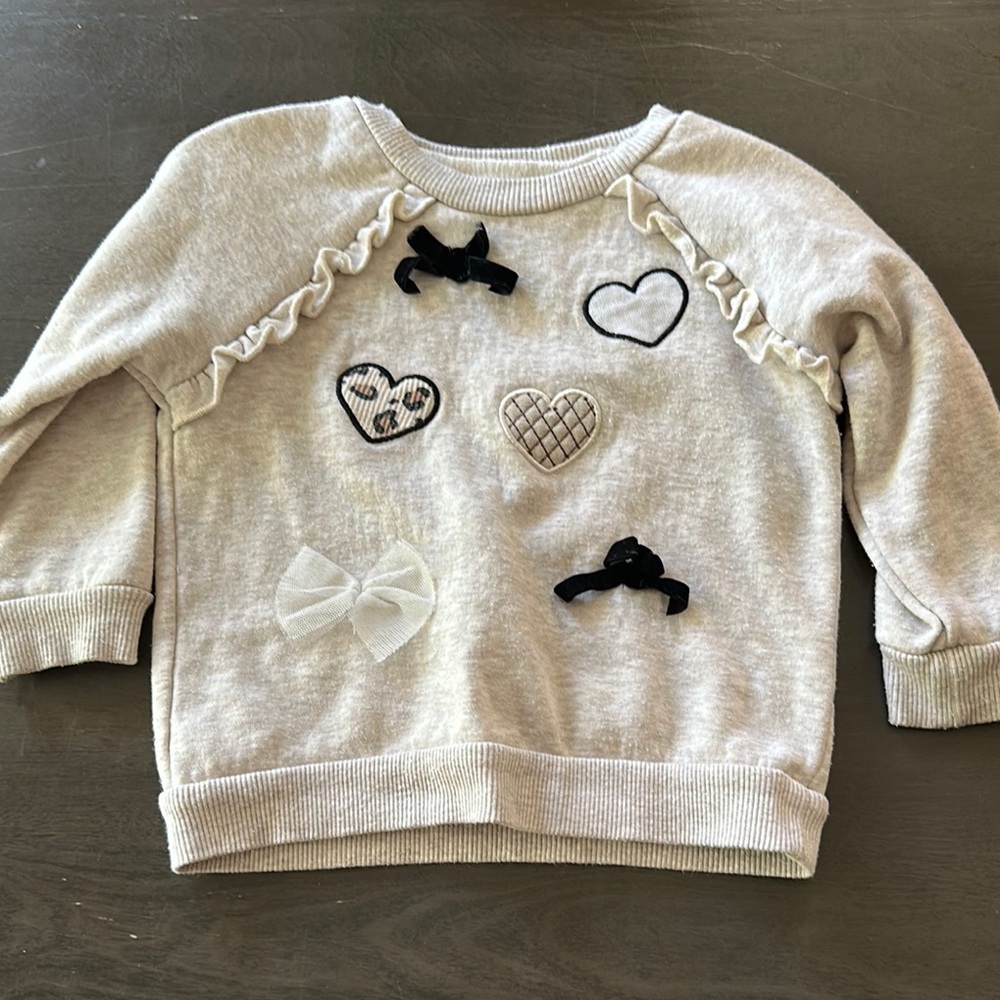 Nannette Cream and Black Heart Sweatshirt with Ruffle Details